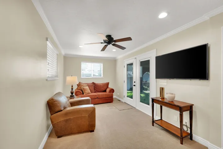 Recessed lighting, crown molding, and a ceiling fan with light fixture