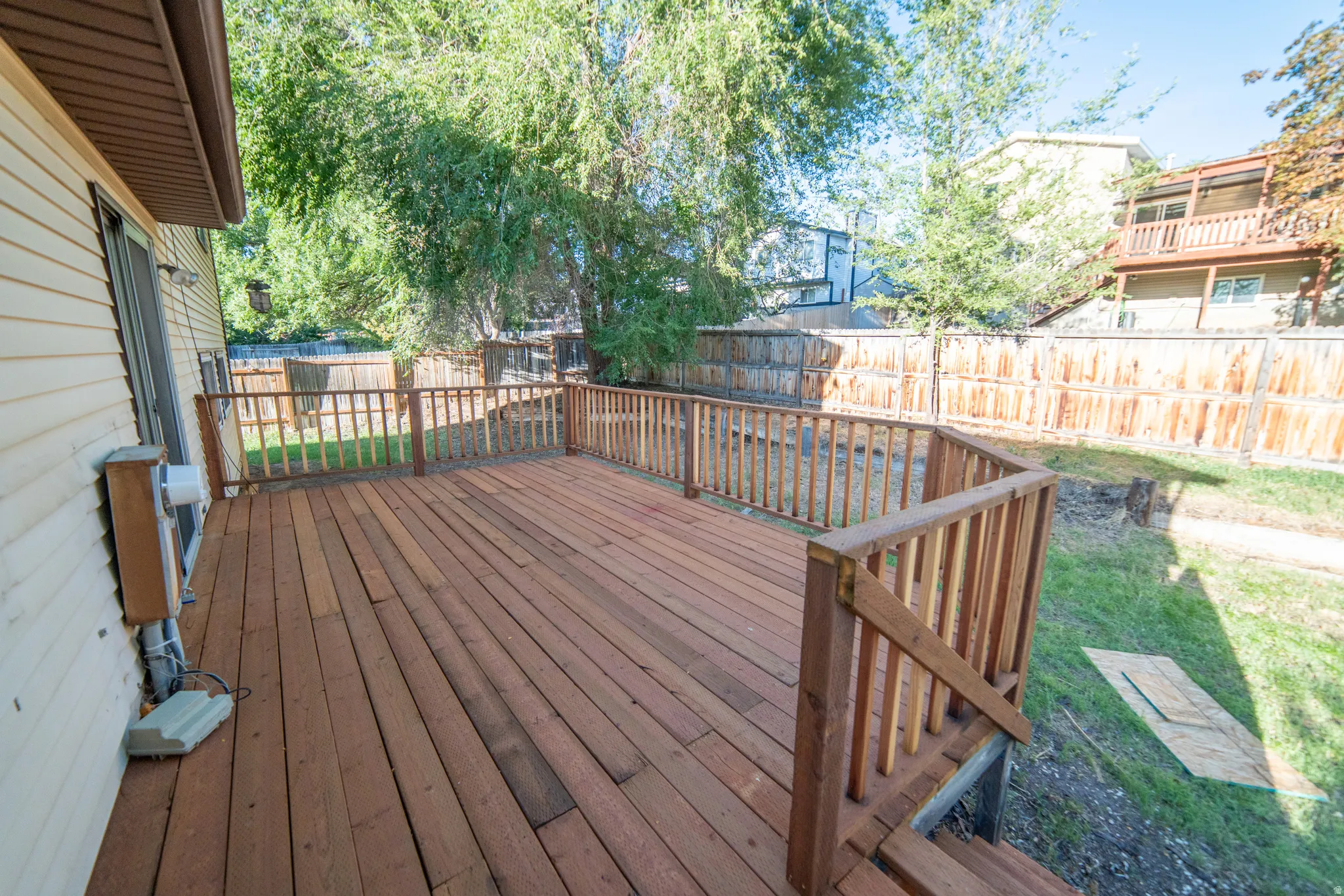 Expansive wood deck with wood plank flooring and wood railing
