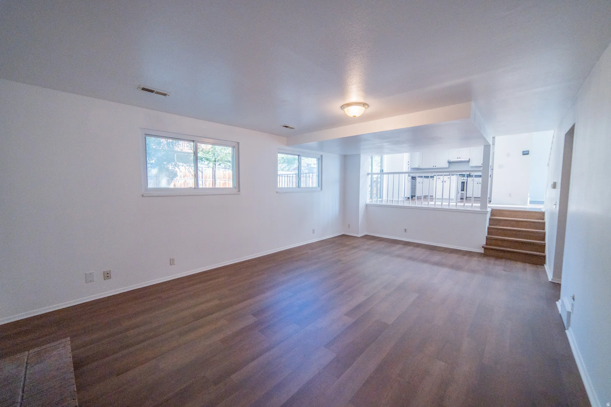 Open-concept living space with wood-finish flooring