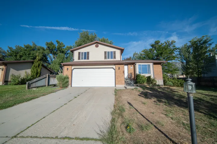 Two-story residence featuring brick and siding exterior, an attached two-car garage, and a concrete driveway