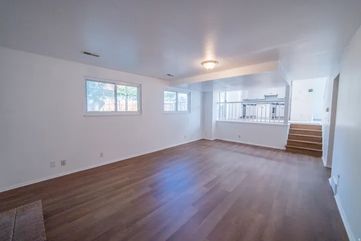 Open-concept living space with wood-finish flooring