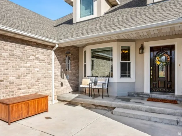 Brick exterior with a dormer window and  welcoming front porch.