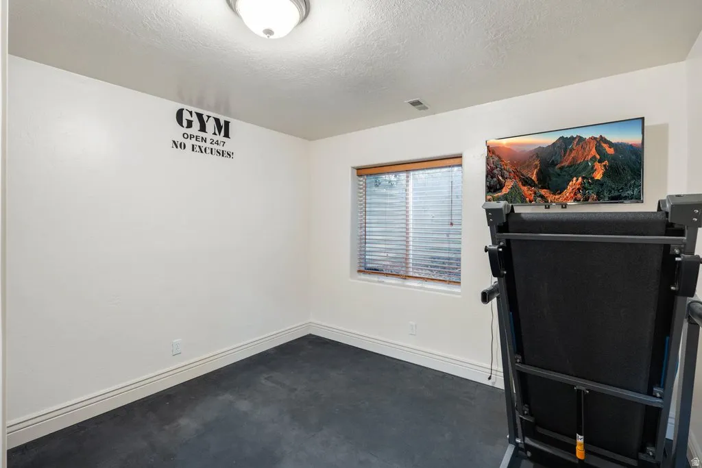 Recessed window with wood-finish trim.  Rubber floor for workouts and equipment.