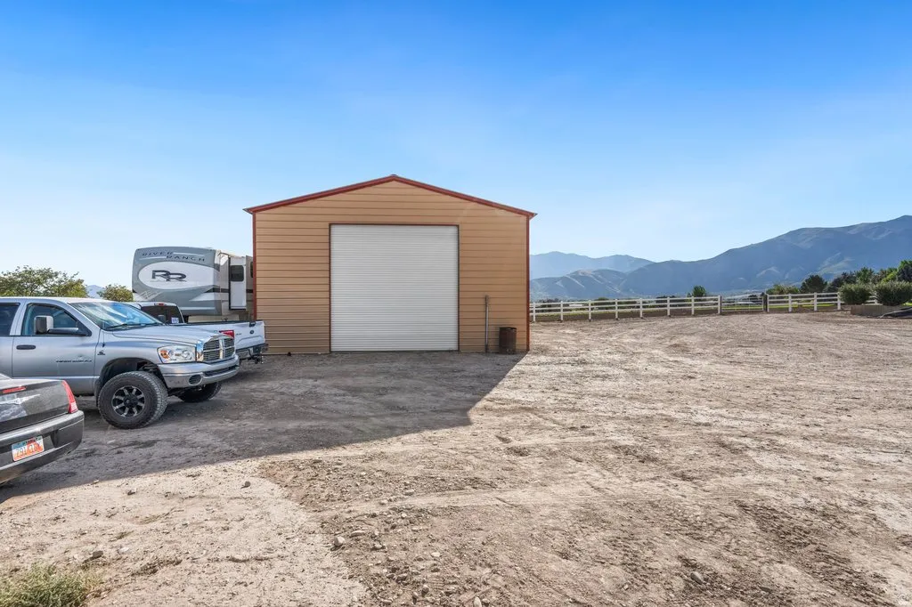 Metal-sided outbuilding with a large garage door for large vehicles/RV's.