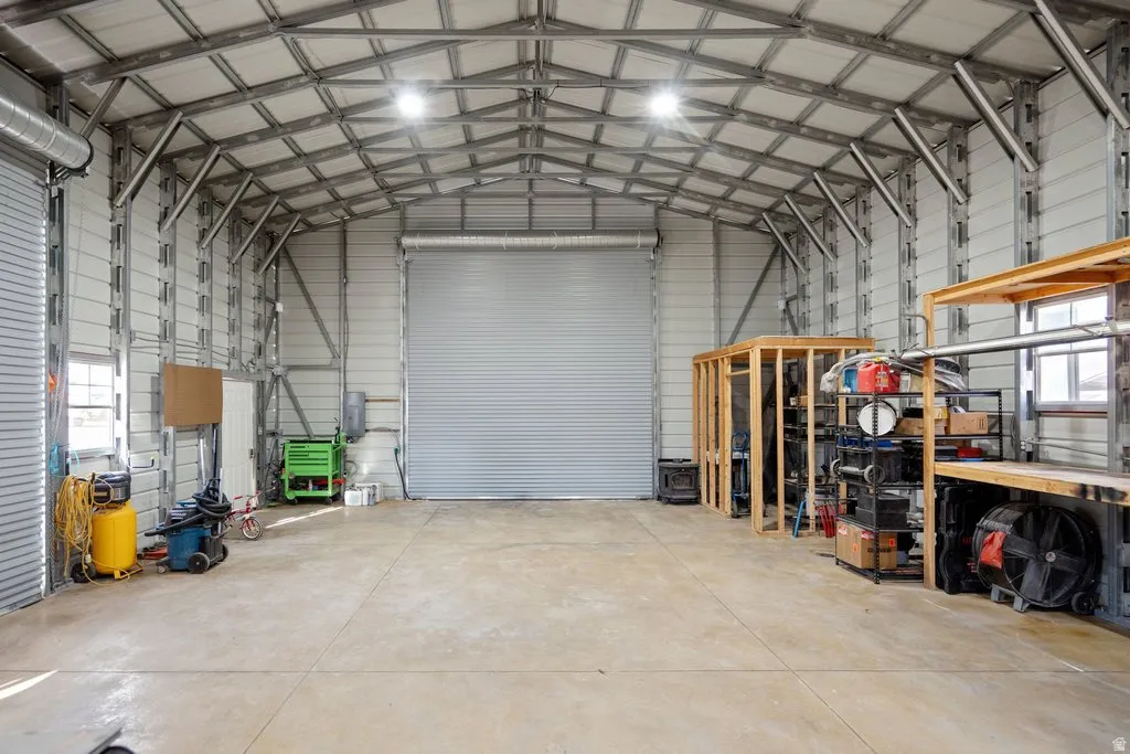 Large metal structure featuring a raidiant heating in the concrete flooring.  An extra large roll up door for RV's and large vehicles.