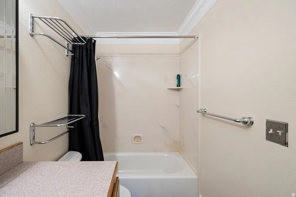 Tub and shower combination with a textured wall surround, complete with an integrated corner shelf