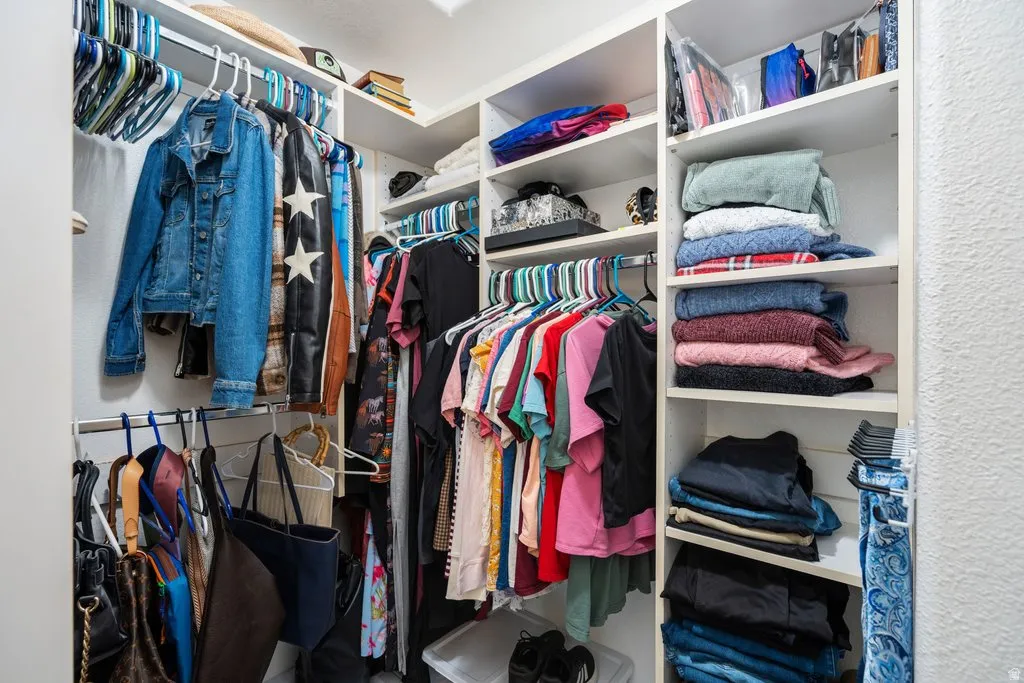 Integrated closet system featuring multiple hanging rods and open shelving