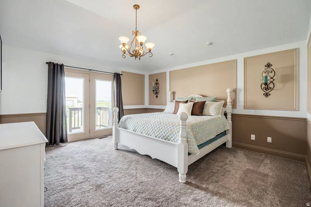 Primary bedroom with French doors  opening to a balcony.