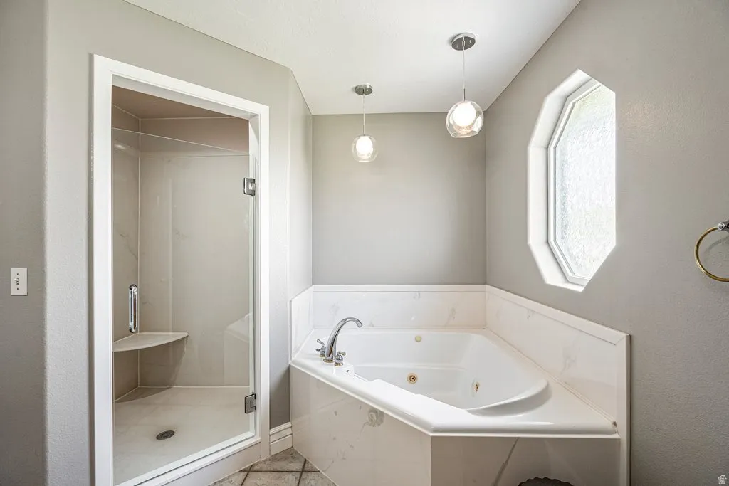 Walk-in shower with a built-in seat, glass enclosure, and tiled interior