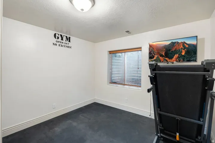 Recessed window with wood-finish trim.  Rubber floor for workouts and equipment.