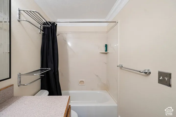 Tub and shower combination with a textured wall surround, complete with an integrated corner shelf