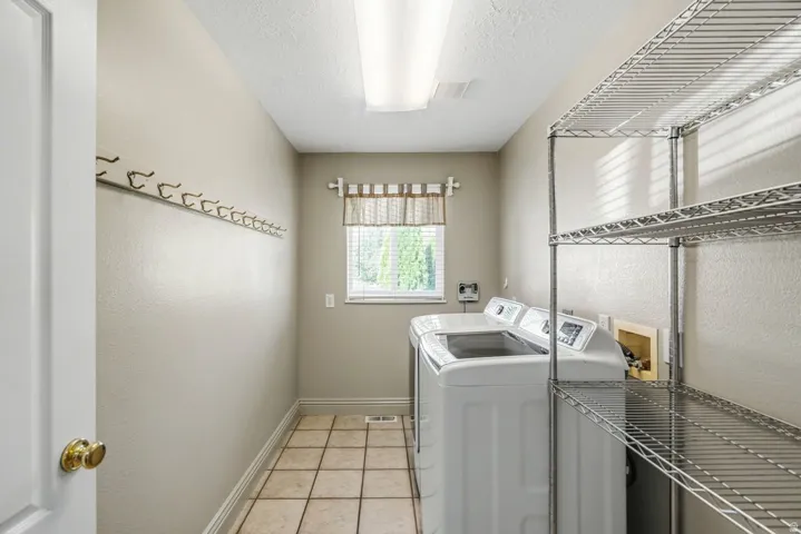 Tiled flooring and a window with blinds