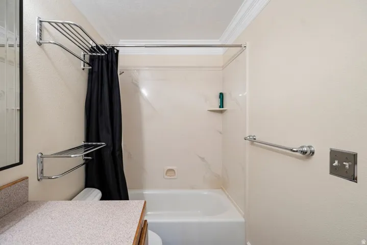 Tub and shower combination with a textured wall surround, complete with an integrated corner shelf