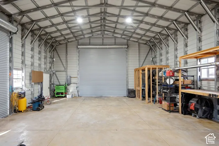 Large metal structure featuring a raidiant heating in the concrete flooring.  An extra large roll up door for RV's and large vehicles.