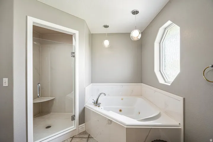 Walk-in shower with a built-in seat, glass enclosure, and tiled interior
