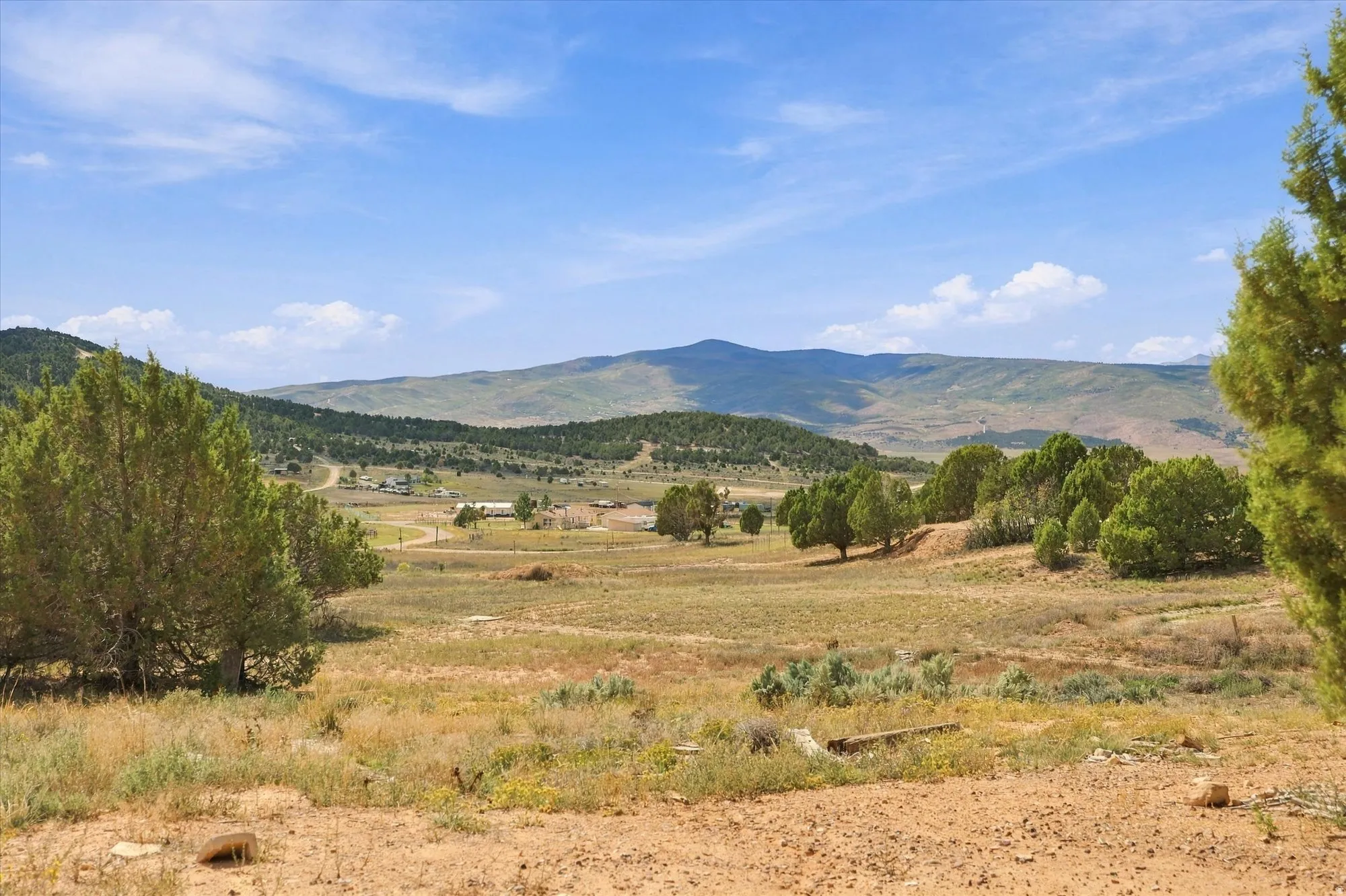 Expansive natural landscape featuring rolling hills and distant mountains