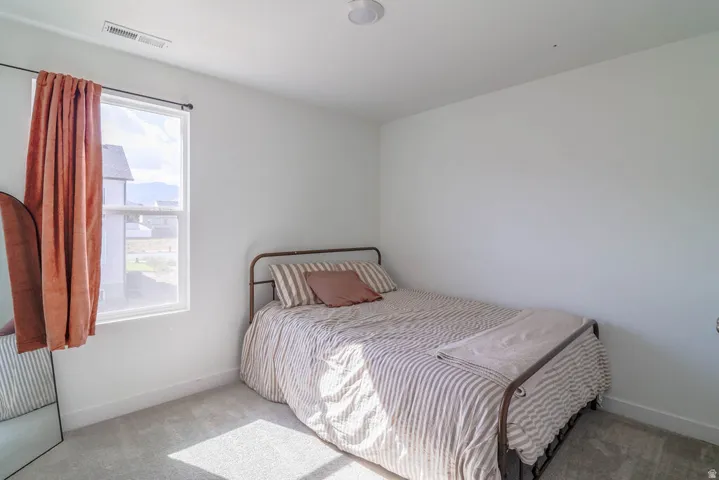 Recessed lighting, single window, white walls, and gray carpet