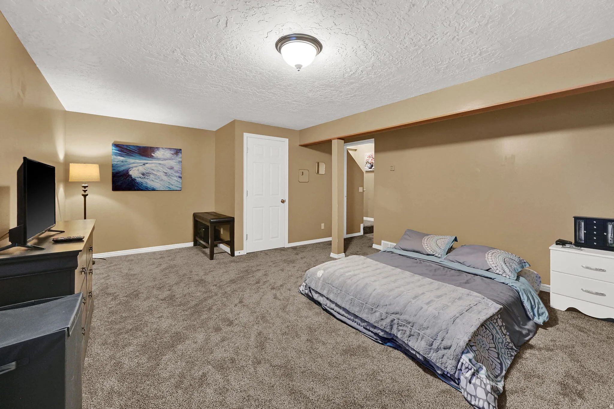 Neutral-toned walls complement the gray carpeting