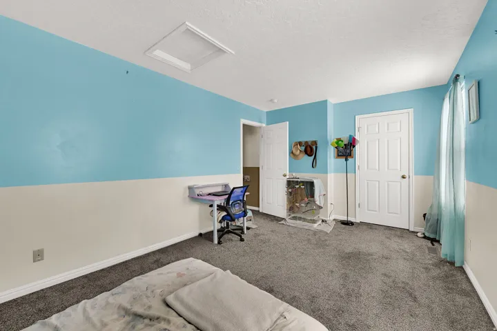 Plush grey carpeting complemented by two-tone wall paint