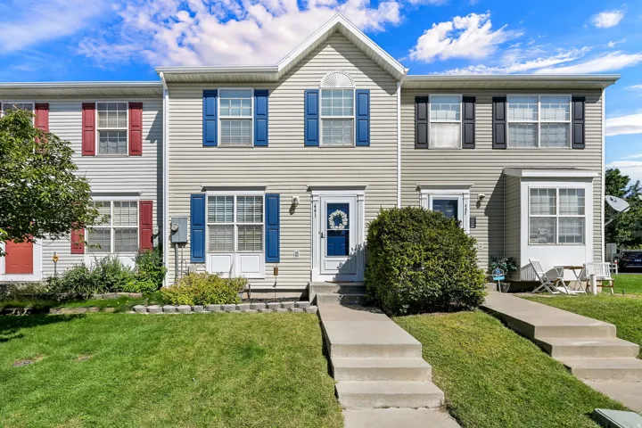 Two-story siding exterior with blue and black window shutters