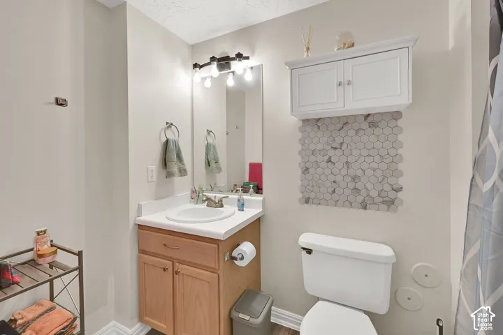 White vanity cabinet with a white countertop and an integrated sink