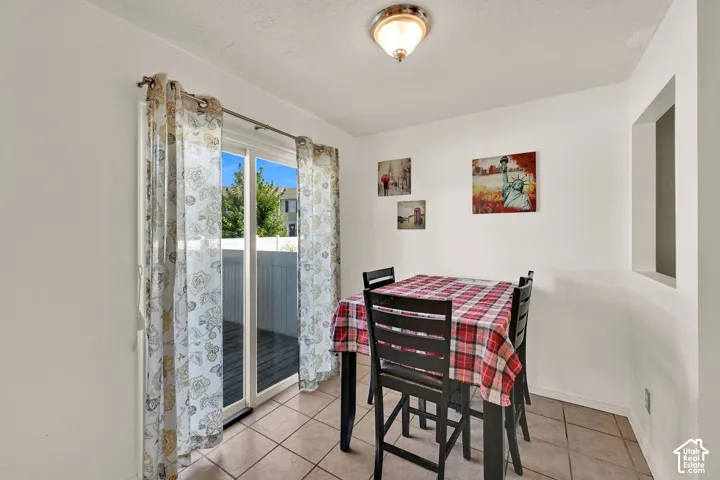 Sliding glass door, recessed wall opening, ceiling-mounted light fixture, tile flooring