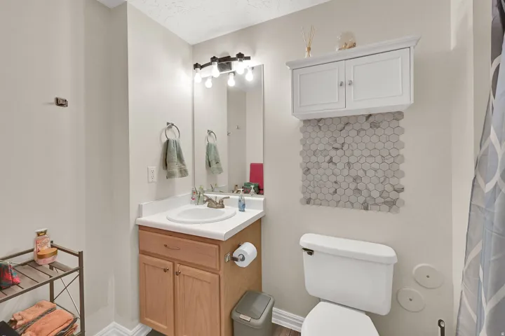 White vanity cabinet with a white countertop and an integrated sink