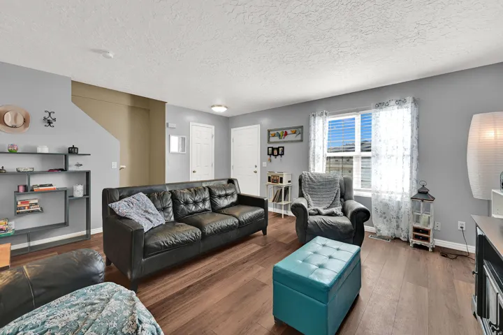 Wood-finish flooring, light gray wall paint, and white trim throughout