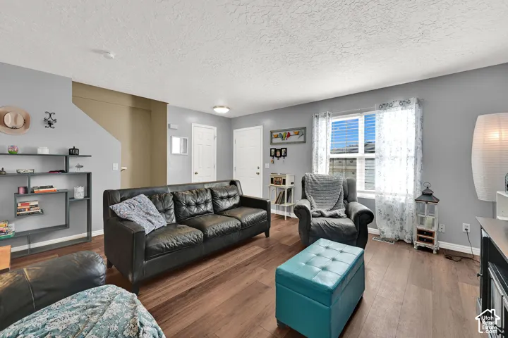 Wood-finish flooring, light gray wall paint, and white trim throughout