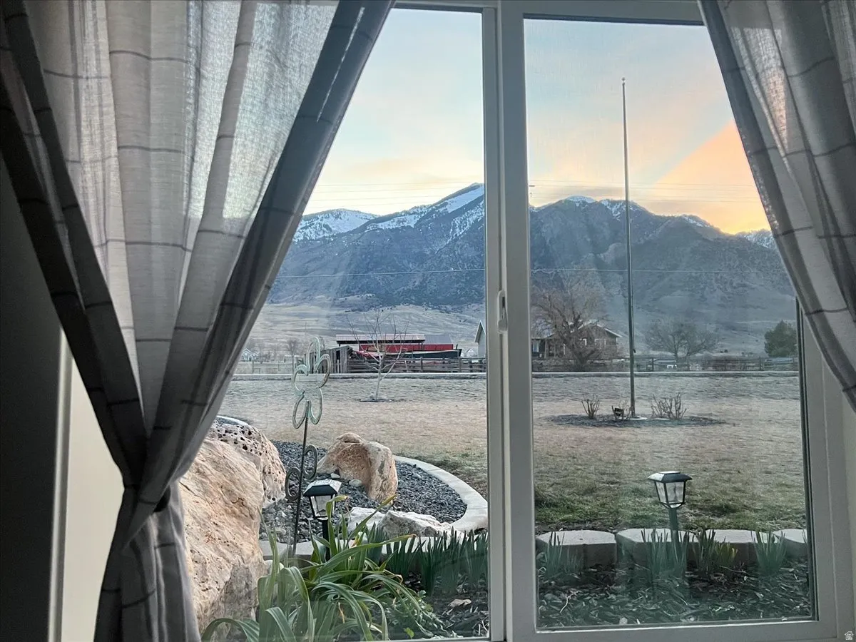 Window providing an expansive mountain backdrop with snow-capped peaks