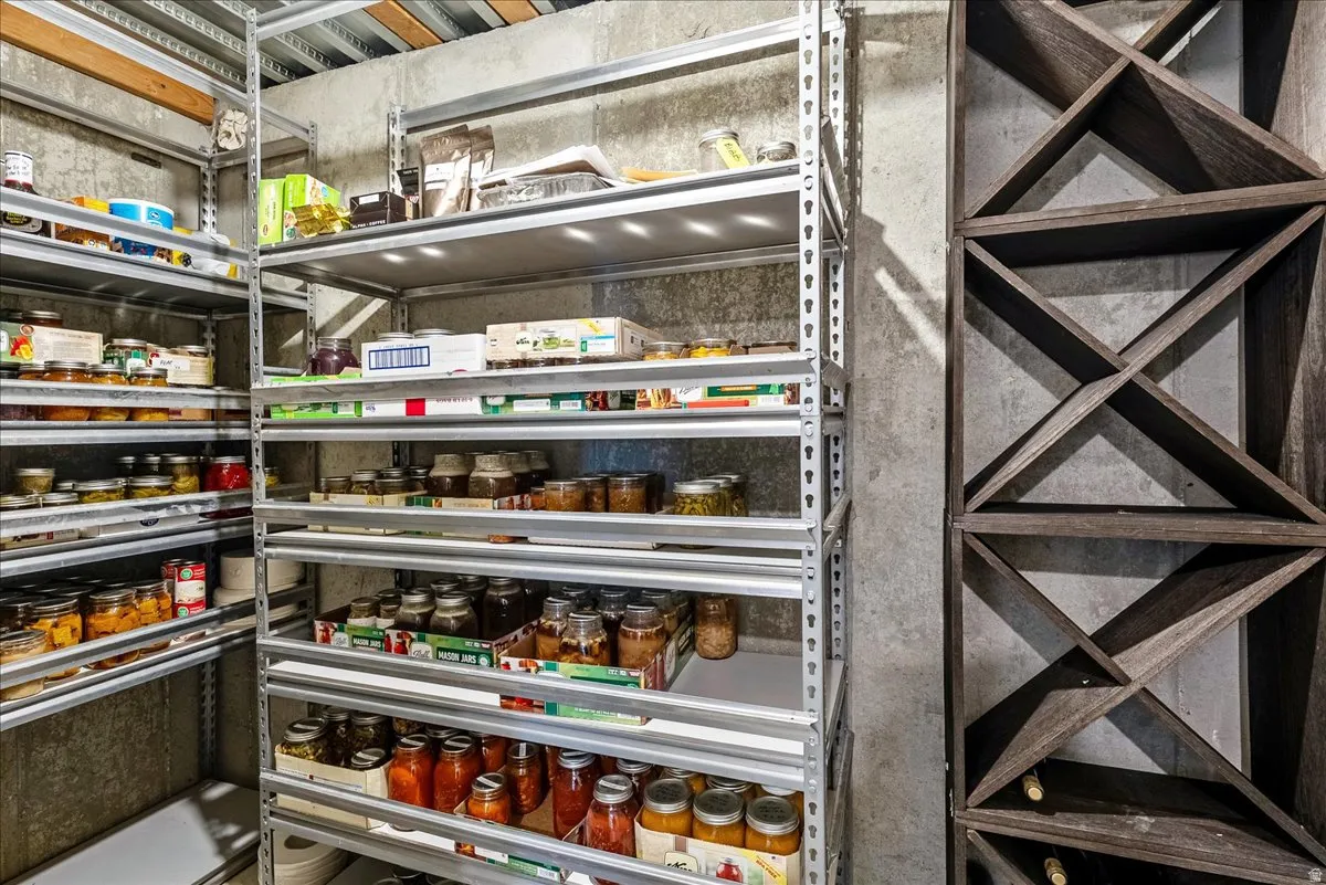 Built-in wine storage and durable metal shelving against a concrete wall