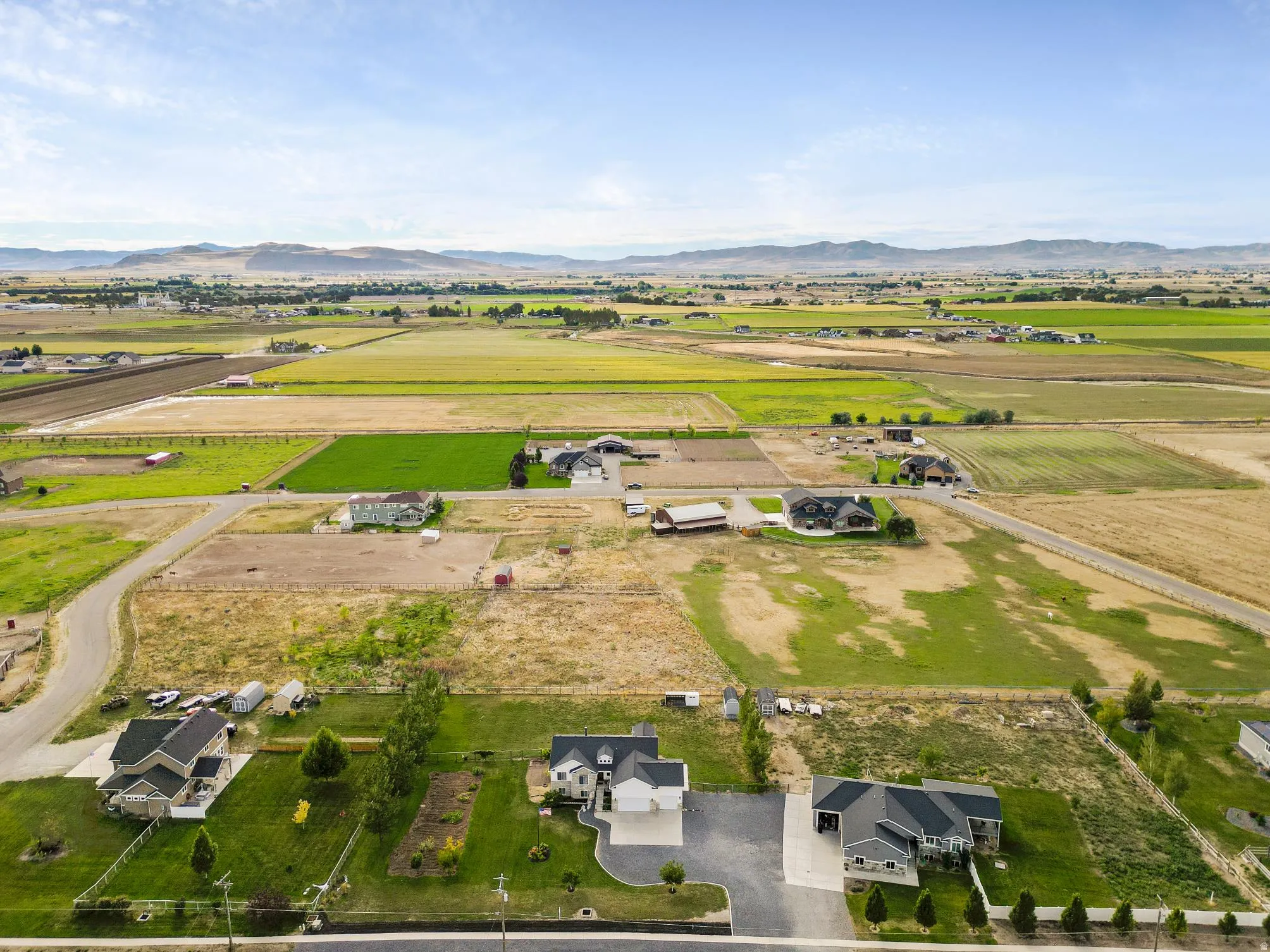 Expansive rural property featuring multiple residential structures and extensive agricultural fields