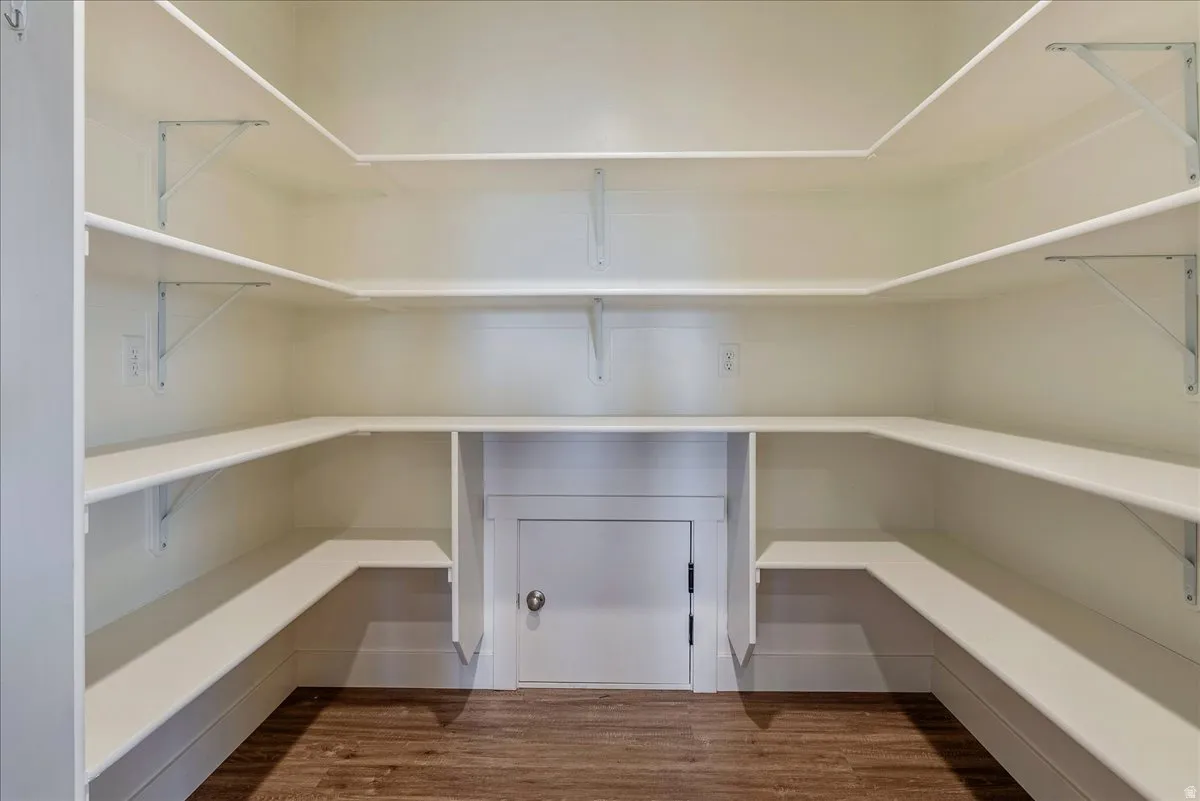 Wrap-around shelving with white finishes and wood-finish flooring