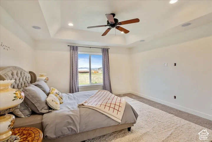 Tray ceiling with recessed lighting, ceiling fan, and built-in speakers