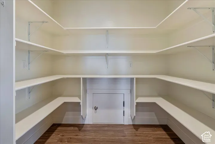 Wrap-around shelving with white finishes and wood-finish flooring