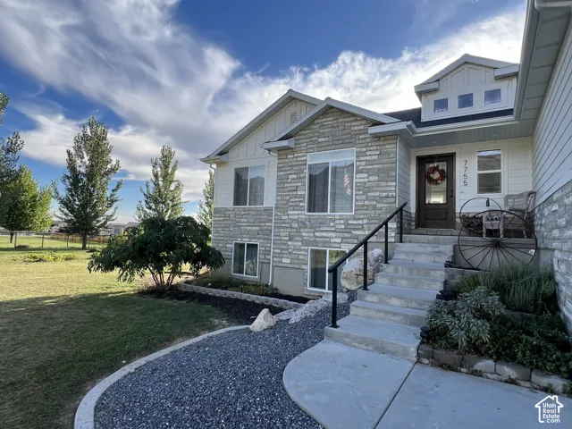 Stone veneer and horizontal siding exterior with multiple windows