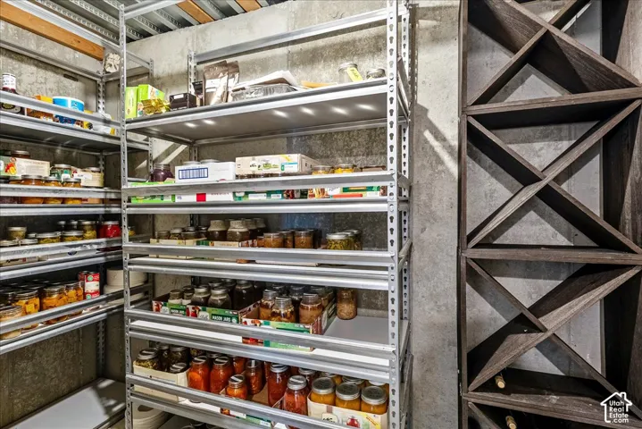 Built-in wine storage and durable metal shelving against a concrete wall