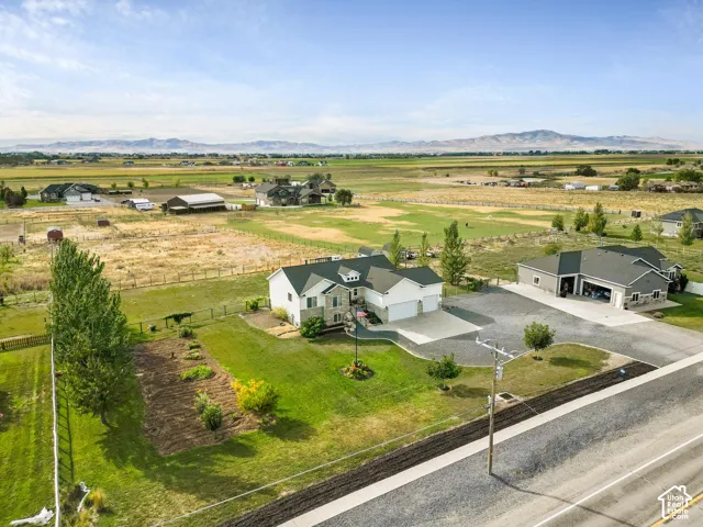 Two-story property featuring a stone and siding exterior, multi-car garage, and a large additional detached garage