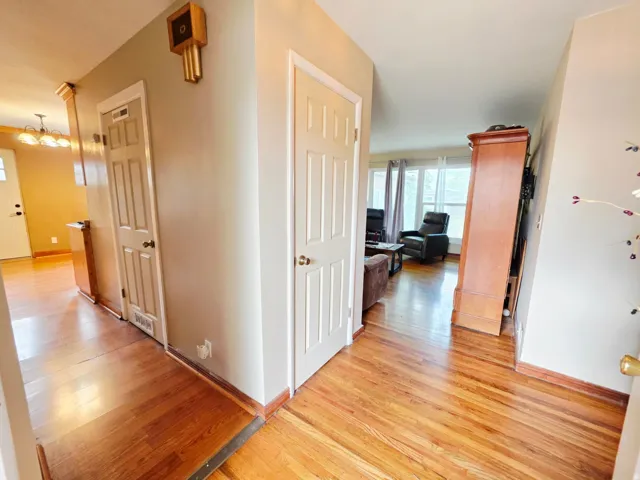 Hardwood flooring throughout, multiple entryways, and natural light from large windows