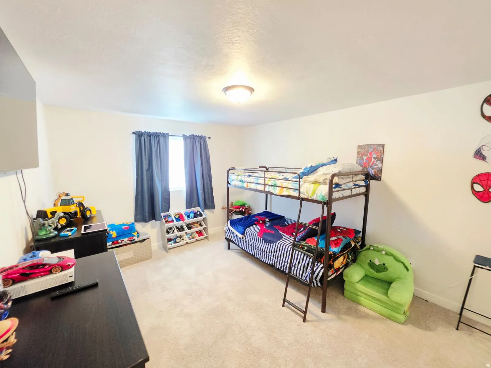 Recessed window with dark blue curtains, neutral wall color, built-in ceiling light fixture, and light-colored carpet