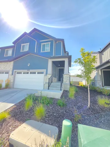 Two-story exterior with blue siding and stone accents