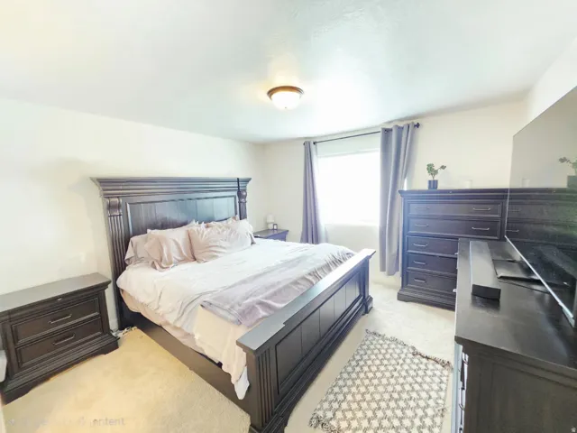 Recessed window with drapes, wall-to-wall carpeting, and a flush mount ceiling light fixture