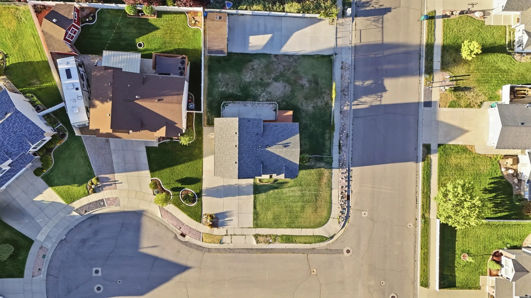 Corner lot property featuring expansive green lawns and mature landscaping