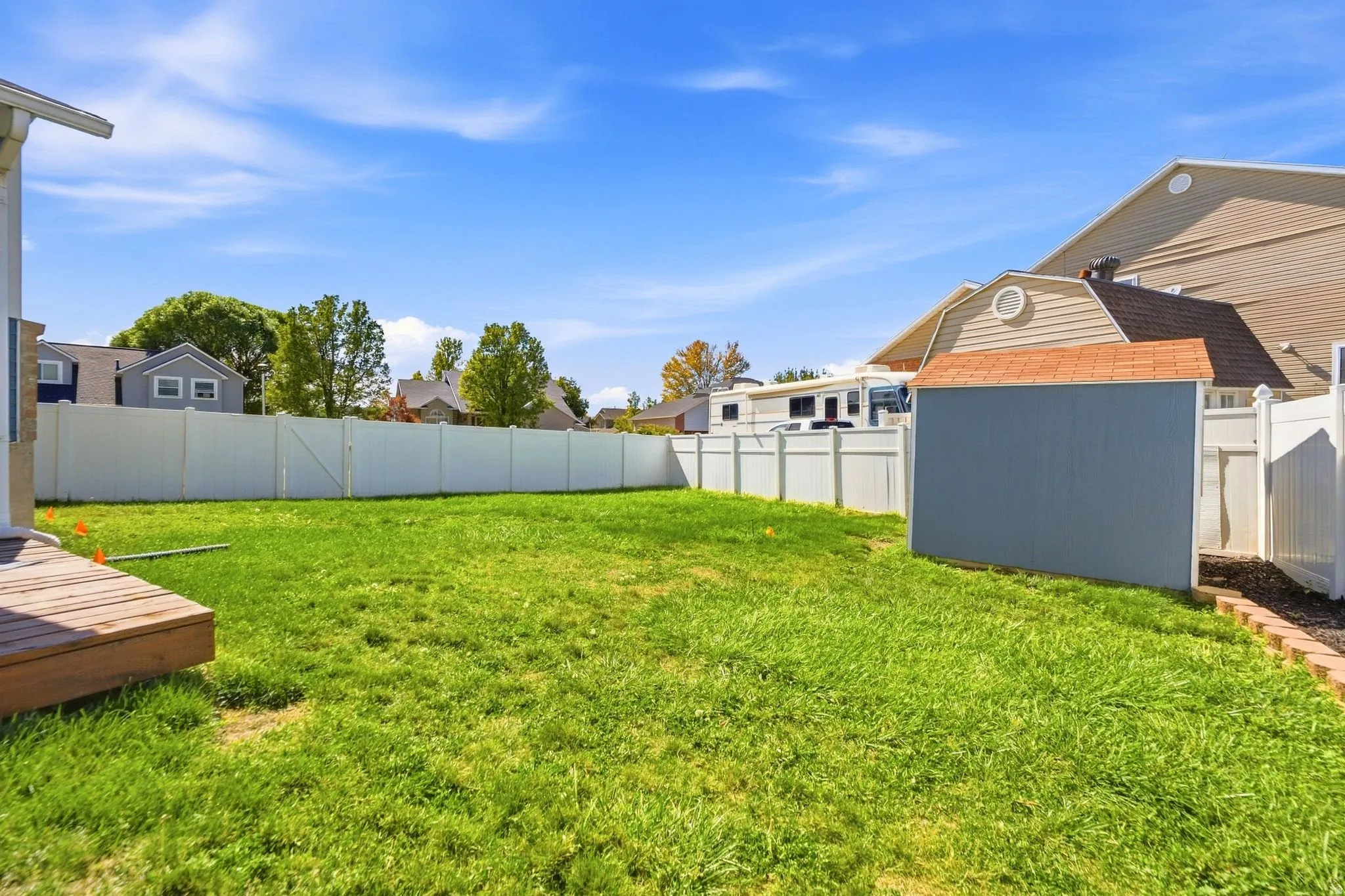 Large grassy area with plenty of room to play, gather, or simply enjoy the extra outdoor space.