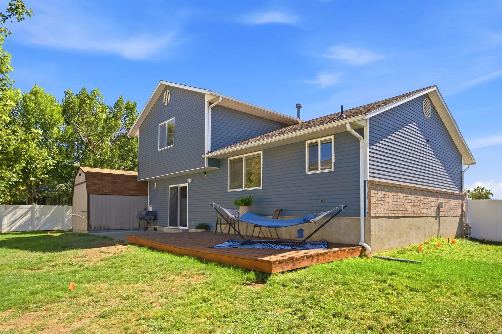 Large patio and spacious deck—perfect for entertaining, relaxing, and enjoying the peaceful backyard.