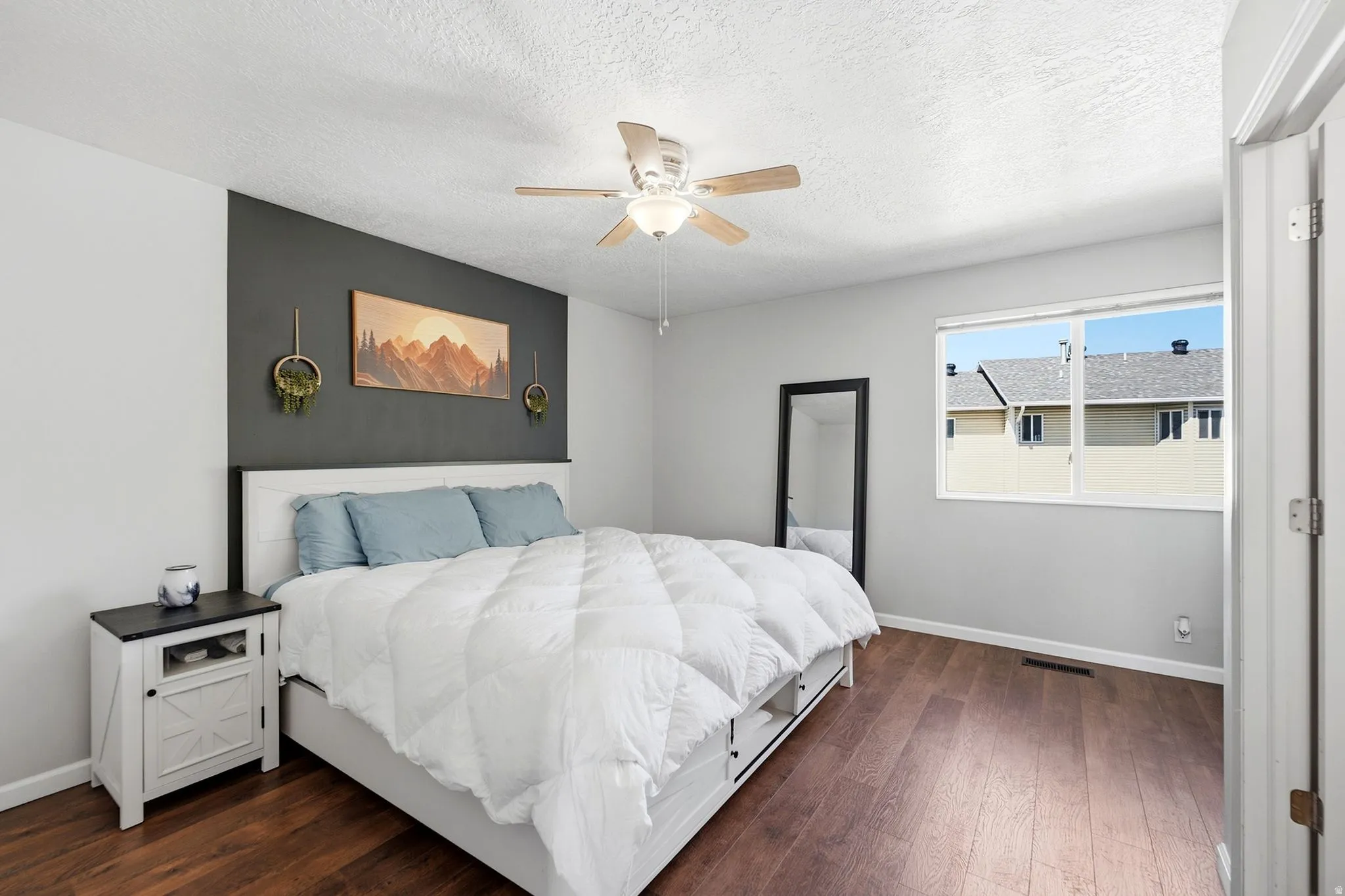 Calm and serene primary bedroom with beautiful accent detailing that adds just the right amount of character.