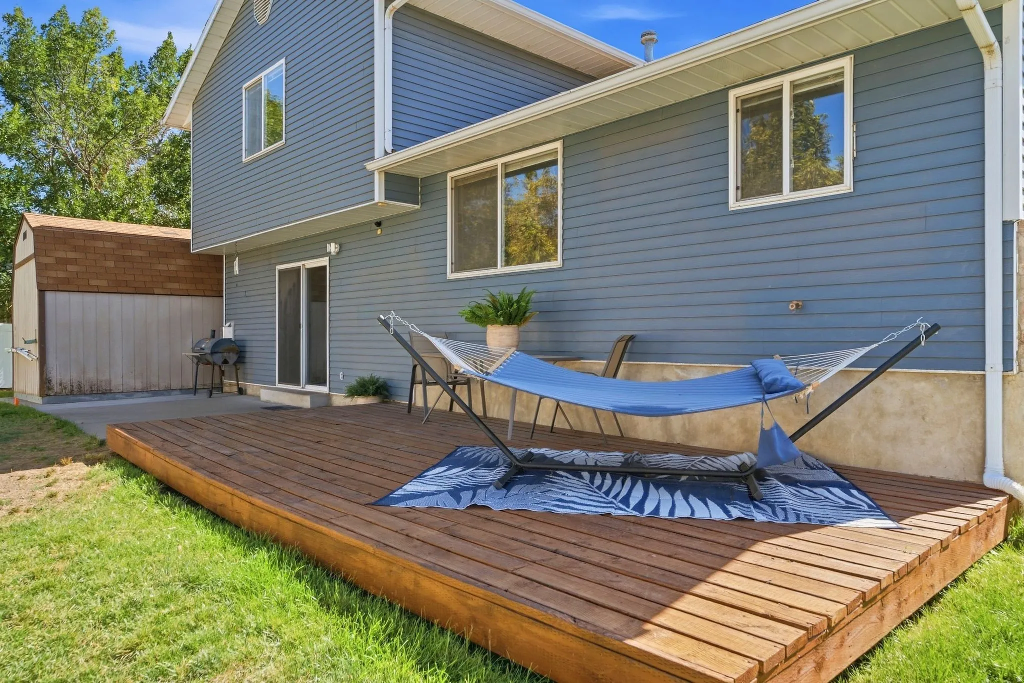 Large patio and spacious deck—perfect for entertaining, relaxing, and enjoying the peaceful backyard.