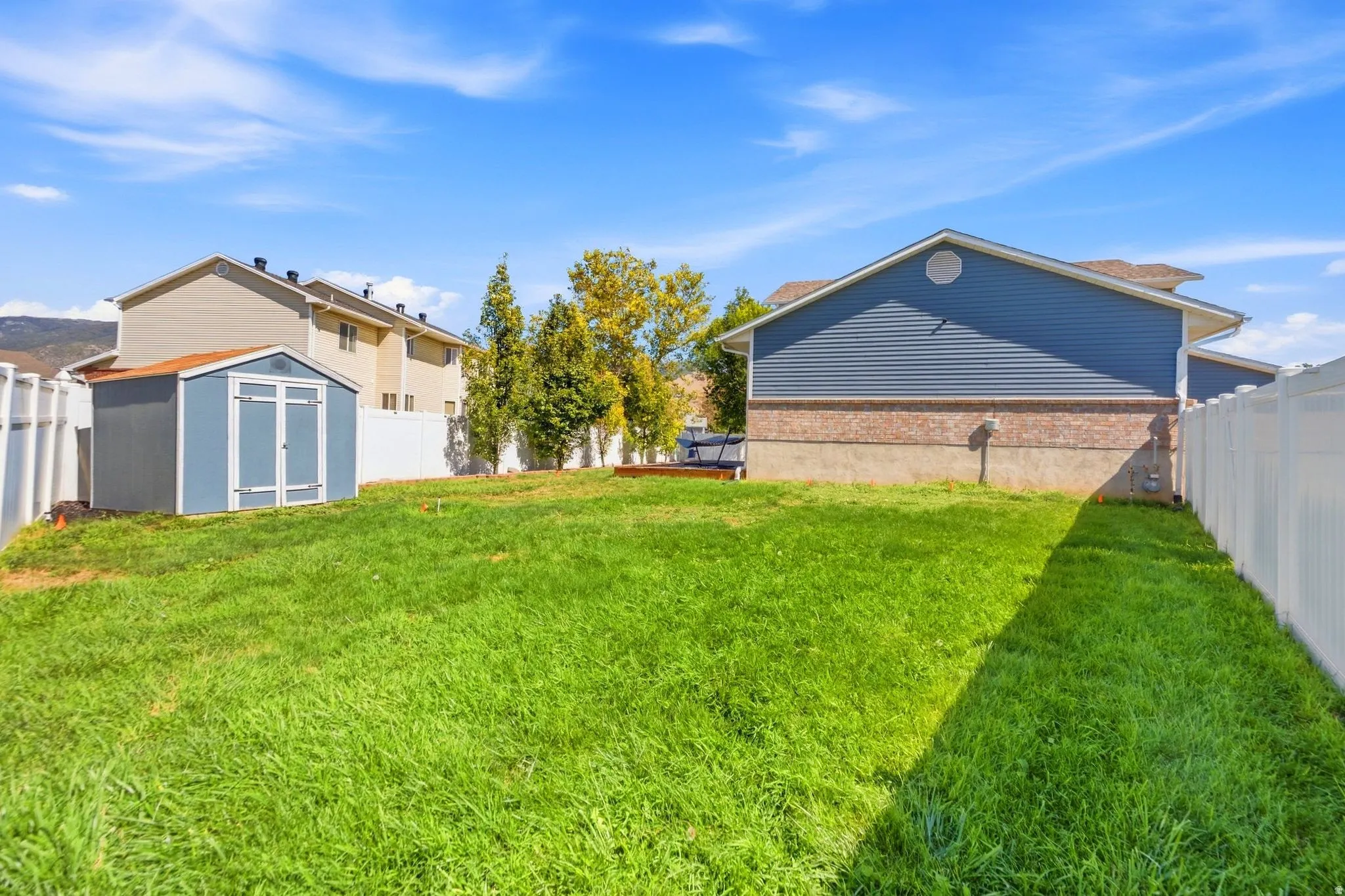 Large grassy area with plenty of room to play, gather, or simply enjoy the extra space—plus a storage shed to keep all the outdoor gear tucked away.