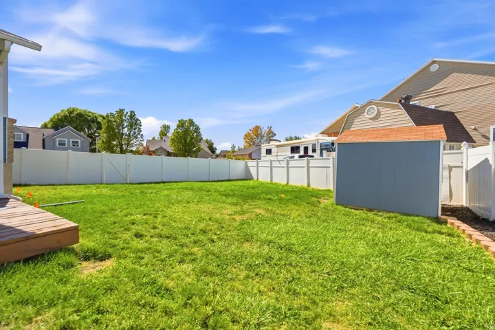Large grassy area with plenty of room to play, gather, or simply enjoy the extra outdoor space.