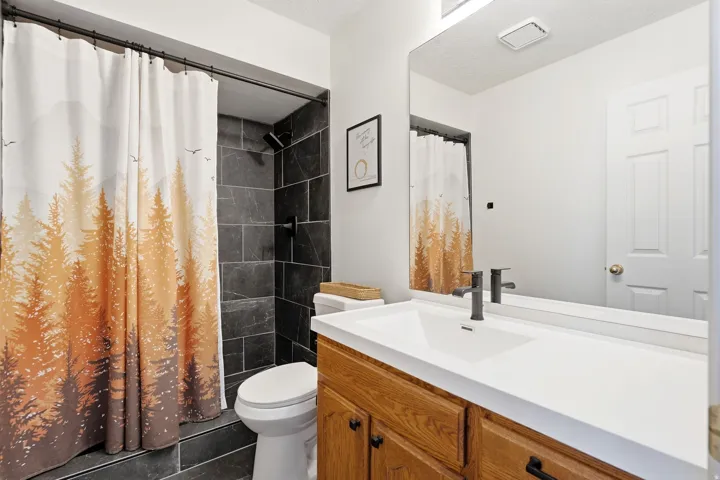 Beautifully updated primary bath featuring a custom tile shower and stylish vanity.